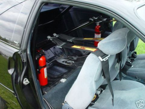 1992 Ford Probe - Interior view of a modified car, identified as a 1992 Ford Probe, equipped with racing safety features.