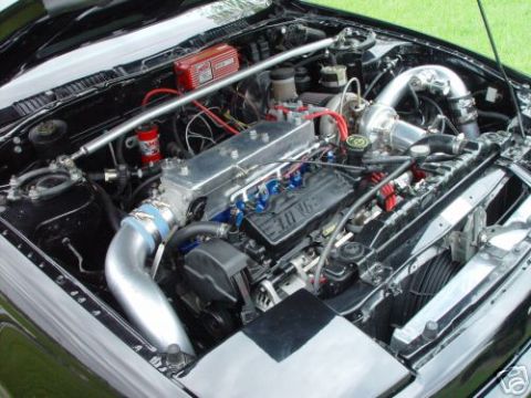 1992 Ford Probe - Engine bay of a 1992 Ford Probe, a modified engine with a turbocharger.