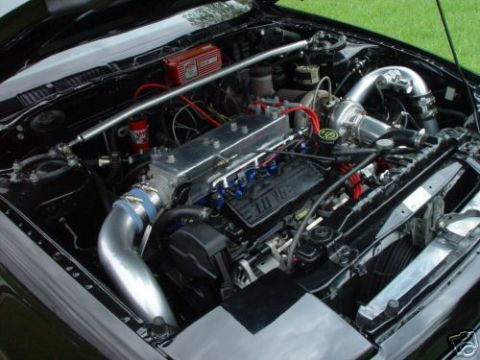 1992 Ford Probe - Customized engine bay with turbocharger and intercooler piping, a 3.0 V6 engine.