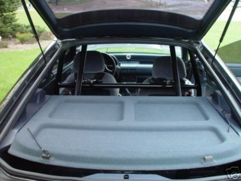 1992 Ford Probe - The interior of a 1992 Ford Probe is visible with a roll cage installed.
