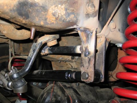 1995 Ford Bronco - Underside view of a vehicle's suspension system, highlighting modified steering and suspension components.