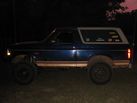 1995 Ford Bronco - This blue 1995 Ford Bronco features a tan removable top and is equipped with off-road tires.