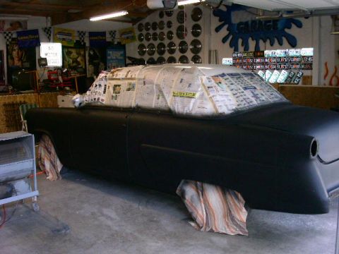 1954 Ford Crestline - A 1954 Ford Crestline is being prepped for new paint in a garage, with its windows covered in newspaper.