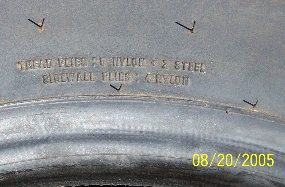 Tire sidewall showing 'TREAD PLIES: 6 NYLON + 2 STEEL SIDEWALL PLIES: 4 NYLON' and date stamp 08/20/2005