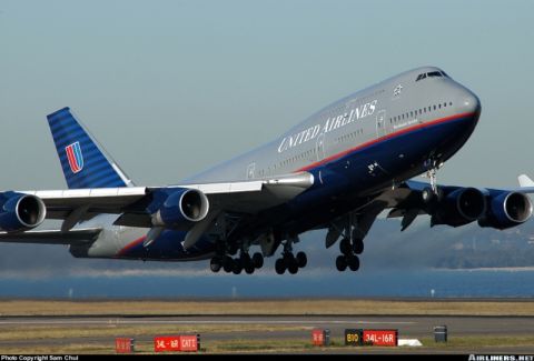 1986 Ford Bronco - A United Airlines Boeing 747 aircraft is captured in a three-quarter front view as it ascends from the runway.
