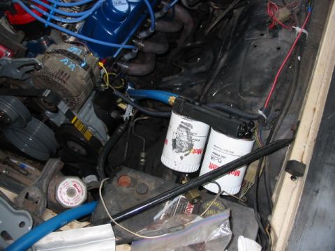 1985 Ford Crown Victoria LTD - Close-up view of an engine bay, focusing on the oil filters and associated engine components.