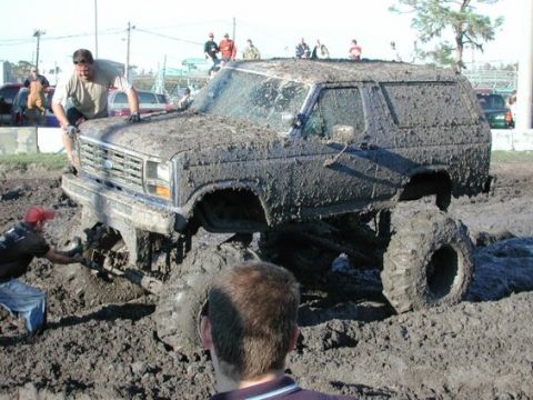 1979 Ford Bronco - Muddy 1979 Ford Bronco stuck deep in a mud pit during an off-road event.