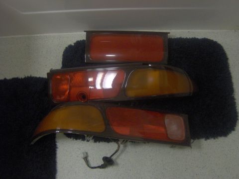 1994 Ford Probe - Car taillights are displayed on a dark fuzzy surface.