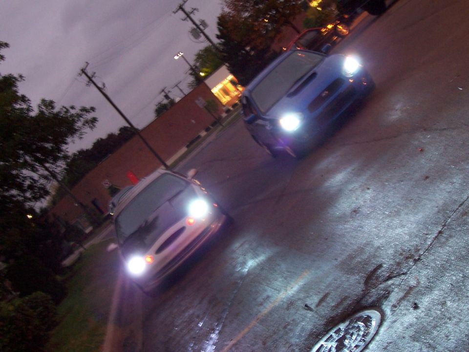 Silver 1998 Mercury Sable with headlights on, angled from the front-right