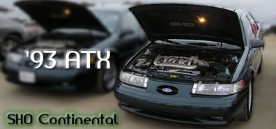 1993 Ford Taurus - This 1993 Ford Taurus SHO features a prominent engine bay with the hood raised.