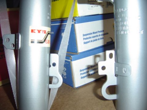 1998 Ford Taurus - Close-up view of KYB suspension components, with boxes of suspension mount products in the background.