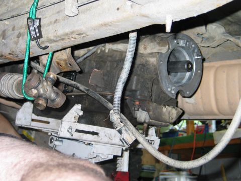1995 Ford Bronco - Underside view of vehicle transmission components, including a driveshaft yoke and U-joint.