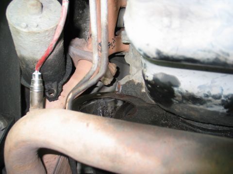 1995 Ford Bronco - Close-up view of engine components, including an exhaust pipe and oxygen sensor.