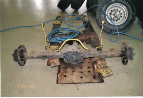1986 Ford Bronco - An axle assembly is shown on a stand, with blue and yellow hoses connected to it. The date stamp '7 20 '05' is visible in the lower left co…