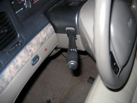 2000 Ford Crown Victoria - Interior view of a 2000 Ford Crown Victoria, focusing on the steering column and dashboard controls.