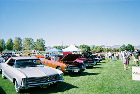 1972 Ford Ranchero - Several classic cars are displayed on a grassy field under a clear blue sky at an outdoor event.