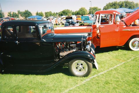 1972 Ford Ranchero - Two classic vehicles parked on grass at an outdoor car show event.