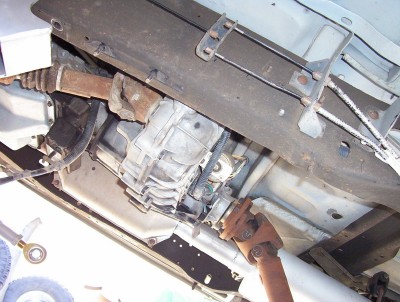 1995 Ford Bronco - The underside of a vehicle is captured, focusing on the transmission and driveshaft components.