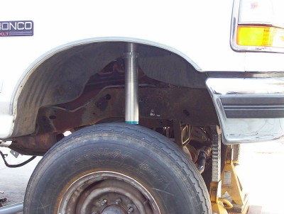 1995 Ford Bronco - Close-up of the rear suspension on a 1995 Ford Bronco, lifted on jack stands.