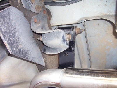 1995 Ford Bronco - Underside view of a vehicle's suspension system, showing a bracket and exhaust pipe.