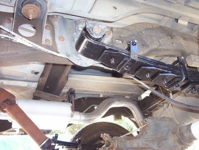 1995 Ford Bronco - Undercarriage view showing the leaf spring suspension and exhaust system of a vehicle.