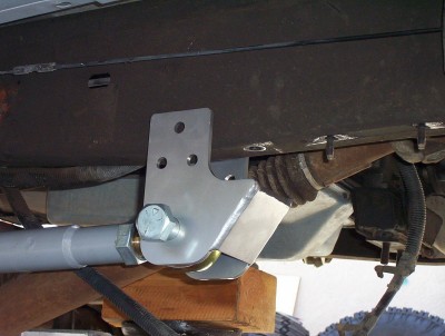 1995 Ford Bronco - Custom suspension bracket being installed on a vehicle's undercarriage.