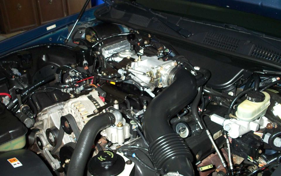 Cleaned V8 engine bay with alternator, black intake tube and brake reservoir
