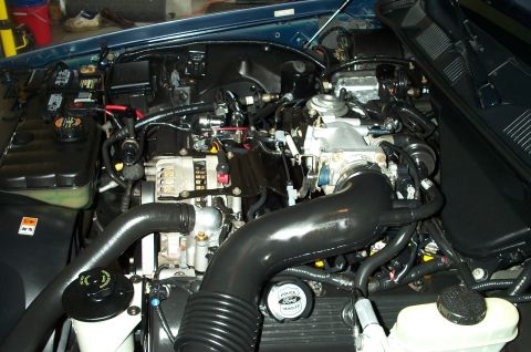 1998 Ford Crown Victoria - Engine bay detail with a Ford branded cap visible.