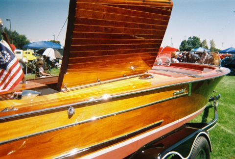 1972 Ford Ranchero - A classic wooden boat with a polished finish is displayed outdoors on a sunny day.