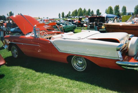 1972 Ford Ranchero - A two-tone convertible with its hood open is displayed on a sunny day at a car show.