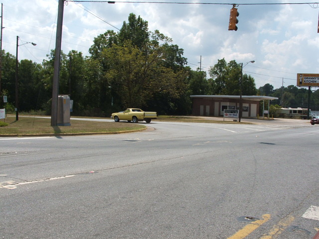 Yellow 1972 Ford Ranchero driving on a road