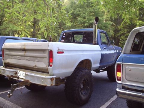 1989 Ford Bronco - Customized Ford pickup truck with a tall exhaust pipe, seen parked outdoors.