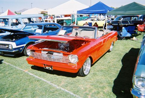 1972 Ford Ranchero - A red 1962 Chevrolet Nova convertible is displayed at an outdoor car show.