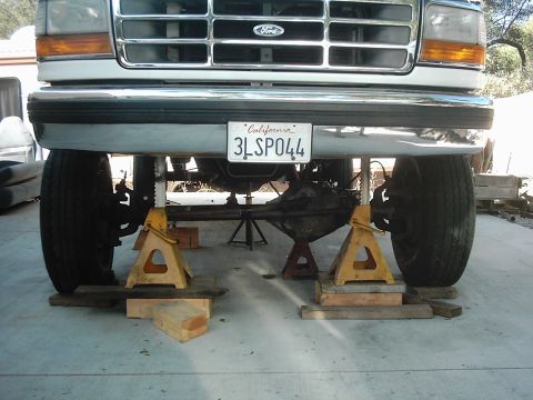 1978 Ford Bronco - This pickup truck is elevated on jack stands, revealing its front axle and suspension components.