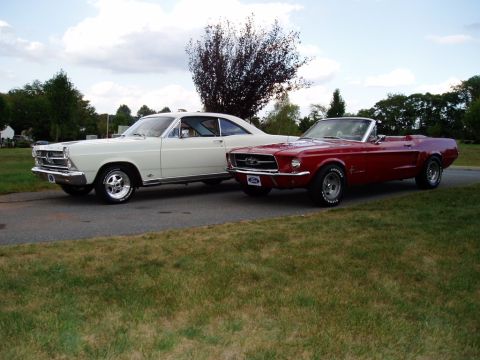 1967 Ford Mustang - A red 1967 Ford Mustang convertible is parked next to a white 1966 Ford Fairlane.