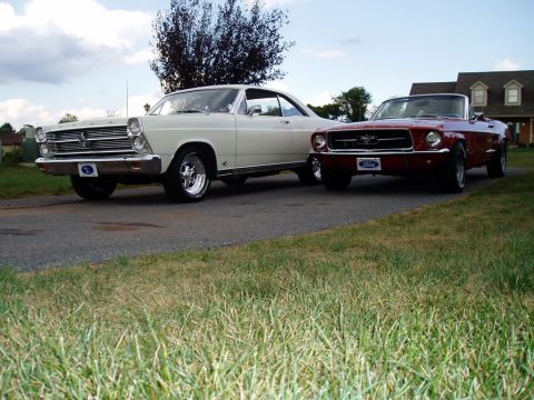 1967 Ford Mustang - A red 1967 Ford Mustang convertible is parked next to a white 1967 Ford Fairlane coupe.