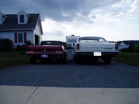 1967 Ford Mustang - Rear view of a red 1967 Ford Mustang convertible and a white 1966 Ford Fairlane parked side-by-side.