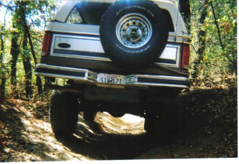 1982 Ford Bronco - This Ford Bronco is navigating a dirt trail in a wooded area.