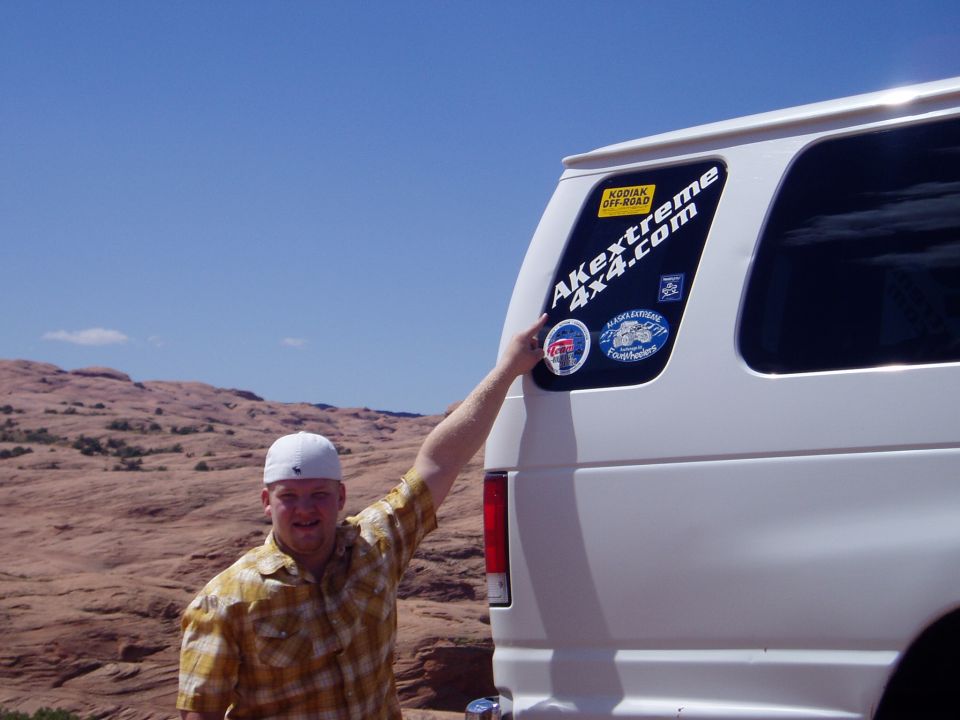 White van rear door with AKextreme 4x4.com and club decals in desert slickrock