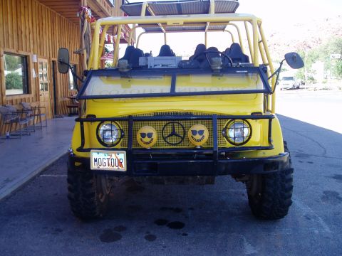 2000 Ford E350 - Custom yellow off-road vehicle with a roll cage and unique grille details.
