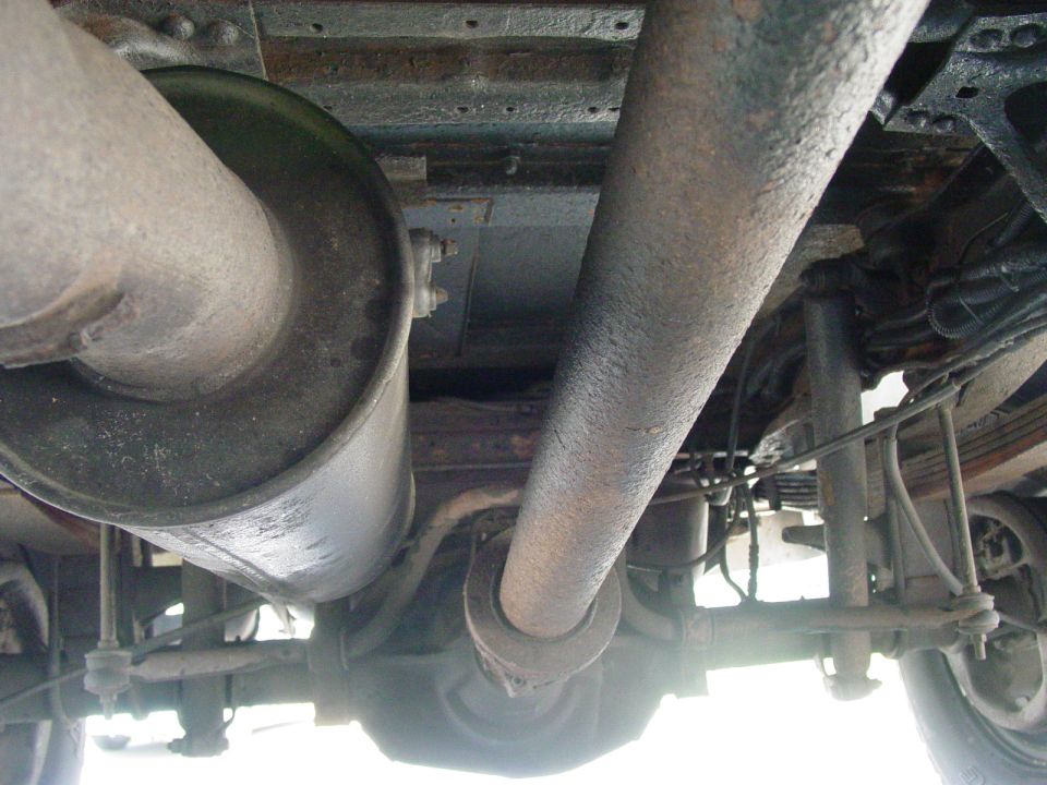 Undercarriage view of truck drivetrain with exhaust and driveshaft