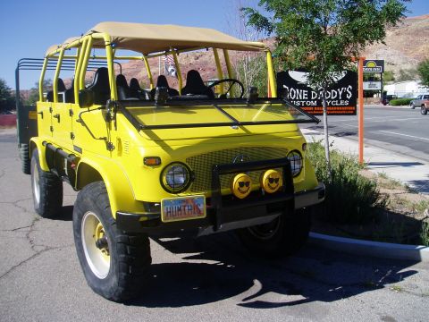 2000 Ford E350 - This yellow off-road vehicle has a unique design with a roll cage and a tan soft top.