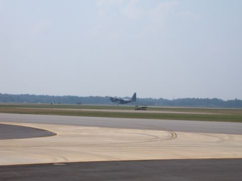 1988 Ford Bronco - An airplane is on the tarmac with a smaller vehicle in the background.