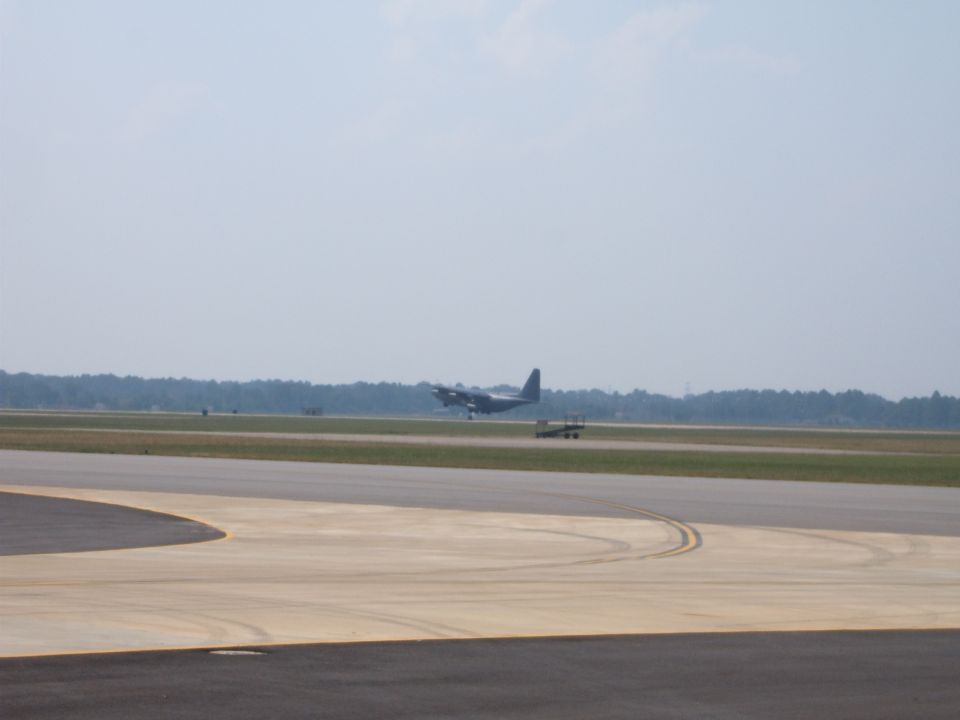 Airplane on tarmac with a smaller vehicle nearby