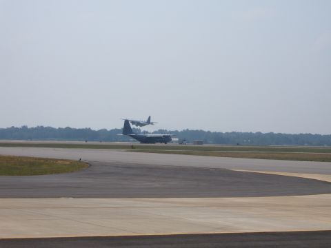 1988 Ford Bronco - Two airplanes are visible on an airport runway under a hazy sky.