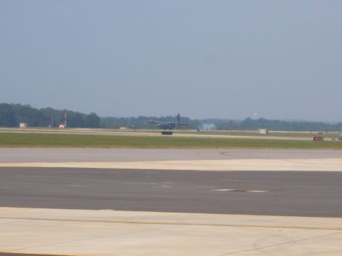 1988 Ford Bronco - Military transport aircraft on runway, possibly during takeoff or landing.