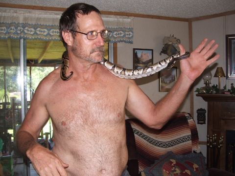 1966 Ford Ranchero - A man poses with a snake draped around his neck and arm.