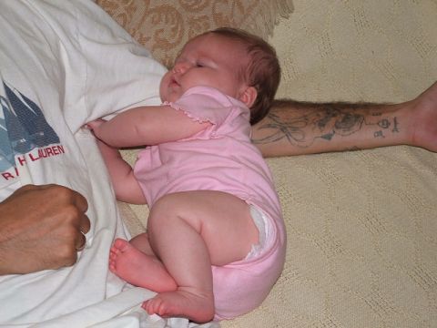 1966 Ford Ranchero - Baby sleeping soundly on an adult, with a tattooed arm resting nearby.