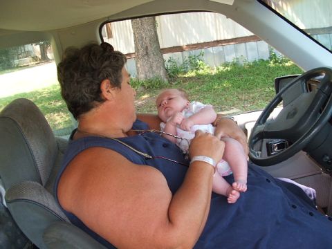 1966 Ford Ranchero - A woman holds a baby while sitting in the driver's seat of a vehicle. The "SUPERMOTORS" logo is visible in the lower right corner.