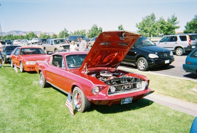 1972 Ford Ranchero - A red 1967 Ford Mustang coupe is displayed with its hood open at an outdoor event.